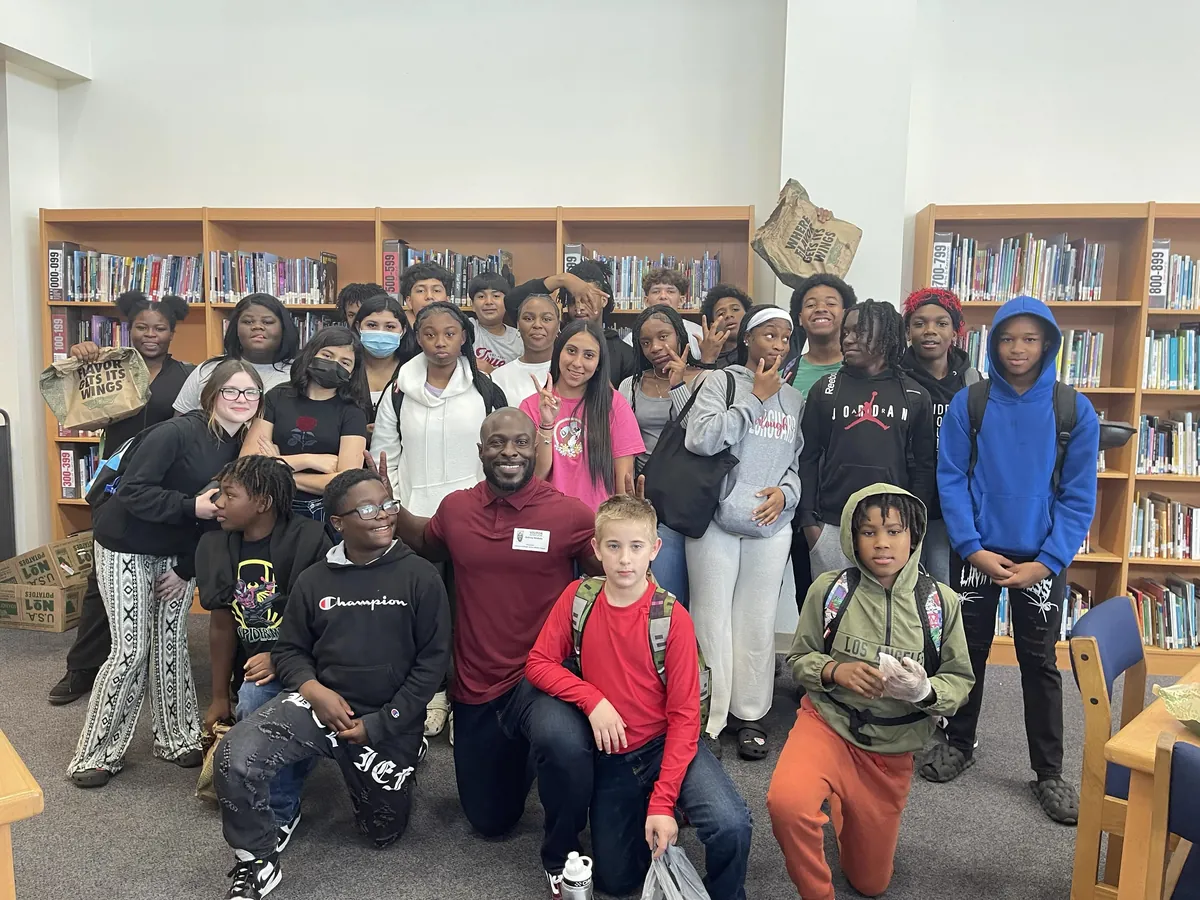 Aubrey McDade Jr. with students during a REAL DEAL mentorship visit